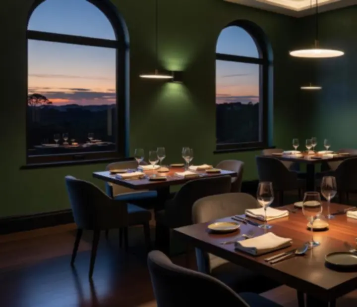 Moody, emerald-lit bistro dining room at The Turn & Table with timber tables and soft lamp light